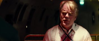 Movie still from “Mission: Impossible III” (2006), directed by J.J. Abrams – A man in a white dress shirt and a red tie; Close Up shot, Overhead angle