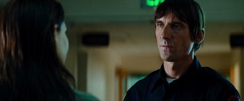 Movie still from “Mission: Impossible III” (2006), directed by J.J. Abrams – A man in a police uniform looking to his left; Close Up shot, Over the shoulder angle