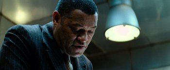 Movie still from “Mission: Impossible III” (2006), directed by J.J. Abrams – A man in a suit looking down at his face; Close Up shot, Low angle