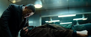 Movie still from “Mission: Impossible III” (2006), directed by J.J. Abrams – A man holding a gun while standing next to a bed; Close Up shot, Low angle