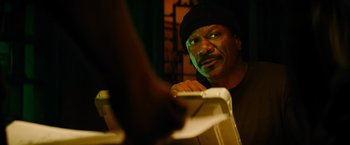 Movie still from “Mission: Impossible III” (2006), directed by J.J. Abrams – A black man with a black hat is looking at the camera; Close Up shot, Low angle