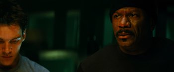 Movie still from “Mission: Impossible III” (2006), directed by J.J. Abrams – A person wearing a black shirt; Close Up shot, High angle