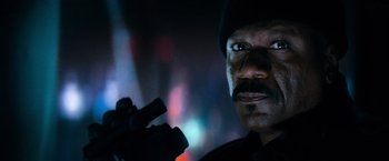 Movie still from “Mission: Impossible III” (2006), directed by J.J. Abrams – A person holding a gun in his hand; Close Up shot, Low angle