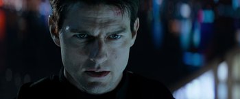 Movie still from “Mission: Impossible III” (2006), directed by J.J. Abrams – A man's face in a dark room; Close Up shot, Over the shoulder angle