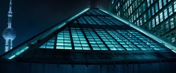 Movie still from “Mission: Impossible III” (2006), directed by J.J. Abrams – A building that has been lit up at night time; Extreme Wide shot, Low angle