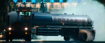 A train is traveling down the tracks in a city