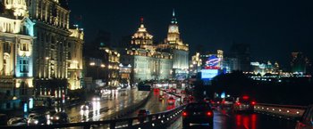 Movie still from “Mission: Impossible III” (2006), directed by J.J. Abrams – Cars driving down a city street at night time; Extreme Wide shot, Low angle
