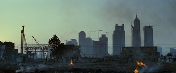 Movie still from “Mission: Impossible III” (2006), directed by J.J. Abrams – A fire is burning in the middle of a city; Extreme Wide shot, Low angle