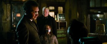 Movie still from “Mission: Impossible III” (2006), directed by J.J. Abrams – A group of people with mouths taped shut; Medium shot, Over the shoulder angle