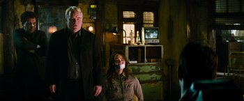 Movie still from “Mission: Impossible III” (2006), directed by J.J. Abrams – A man and a woman with their mouths taped shut in a living room; Medium shot, Over the shoulder angle