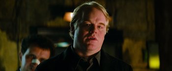 Movie still from “Mission: Impossible III” (2006), directed by J.J. Abrams – A person wearing a suit and tie; Close Up shot, Over the shoulder angle