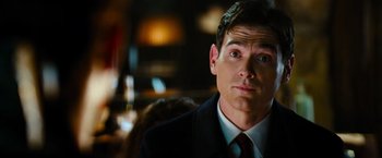 Movie still from “Mission: Impossible III” (2006), directed by J.J. Abrams – A man in a suit and tie; Close Up shot, Over the shoulder angle