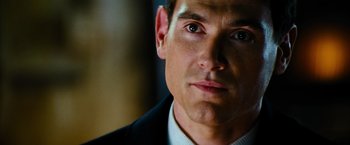 Movie still from “Mission: Impossible III” (2006), directed by J.J. Abrams – A person wearing a suit and tie; Close Up shot, Over the shoulder angle