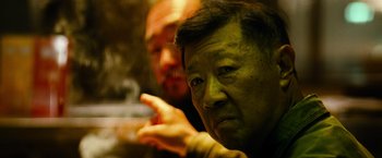 Movie still from “Mission: Impossible III” (2006), directed by J.J. Abrams – Two men are sitting in front of each other; Close Up shot, Low angle