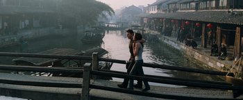Movie still from “Mission: Impossible III” (2006), directed by J.J. Abrams – A man and a woman walking on a bridge over a river; Wide shot, High angle