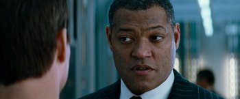Movie still from “Mission: Impossible III” (2006), directed by J.J. Abrams – A man in a suit and a tie; Close Up shot, Over the shoulder angle