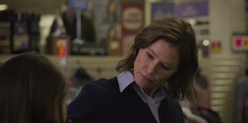 Movie still from “Mixtape” (2021), directed by Valerie Weiss – A person standing in a room; Close Up shot, Over the shoulder angle