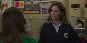 Movie still from “Mixtape” (2021), directed by Valerie Weiss – A woman standing next to another woman in a store; Medium shot, Over the shoulder angle