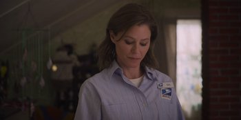 Movie still from “Mixtape” (2021), directed by Valerie Weiss – A woman in a blue shirt is looking down at her face; Close Up shot, Low angle