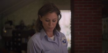 Movie still from “Mixtape” (2021), directed by Valerie Weiss – A woman in a blue shirt is looking down at her face; Close Up shot, Low angle