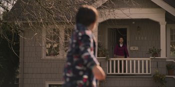 Movie still from “Mixtape” (2021), directed by Valerie Weiss – A young boy and a young woman standing in front of a house; Extreme Wide shot, Over the shoulder angle