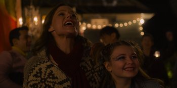 Movie still from “Mixtape” (2021), directed by Valerie Weiss – Two young women are laughing together at a party; Close Up shot, Low angle