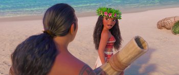 Movie still from “Moana” (2016), directed by Chris Williams – A young woman is standing on the beach with a hula girl; Close Up shot, Over the shoulder angle