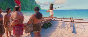 Movie still from “Moana” (2016), directed by Chris Williams – A couple of people standing on top of a boat on a beach; Wide shot, Over the shoulder angle