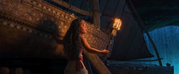 Movie still from “Moana” (2016), directed by Chris Williams – A woman holding a torch in front of a boat; Wide shot, Over the shoulder angle