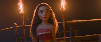 Movie still from “Moana” (2016), directed by Chris Williams – A young girl is standing in front of a tiki torch; Close Up shot, Low angle