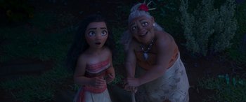 Movie still from “Moana” (2016), directed by Chris Williams – A couple of people standing next to each other on a field; Medium shot, High angle