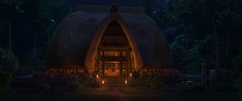 Movie still from “Moana” (2016), directed by Chris Williams – A group of people sitting in front of a building; Extreme Wide shot, Low angle