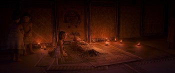 Movie still from “Moana” (2016), directed by Chris Williams – A woman laying on the ground next to a child; Wide shot, High angle