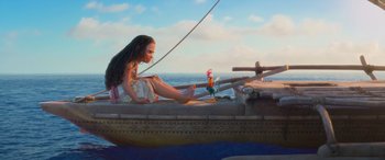 Movie still from “Moana” (2016), directed by Chris Williams – A woman sitting in a boat on the water; Wide shot, Low angle