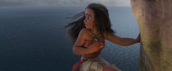Movie still from “Moana” (2016), directed by Chris Williams – A woman in a red top is standing in front of a body of water; Medium shot, Overhead angle