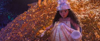 Movie still from “Moana” (2016), directed by Chris Williams – A woman holding a toothbrush in a shell costume; Medium shot, Overhead angle