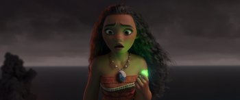 Movie still from “Moana” (2016), directed by Chris Williams – A young woman holding a green light in her hand; Close Up shot, Over the shoulder angle