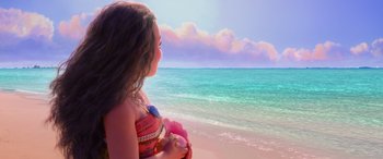 Movie still from “Moana” (2016), directed by Chris Williams – A woman standing on the beach looking out at the ocean; Wide shot, Over the shoulder angle