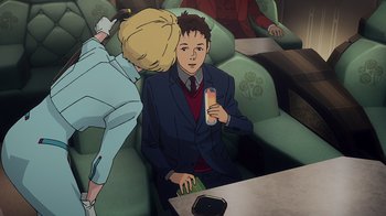 Movie still from “Mobile Suit Gundam: Hathaway” (2021), directed by Shûkô Murase – A man and a woman sitting on a couch; Medium shot, High angle