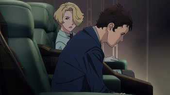 Movie still from “Mobile Suit Gundam: Hathaway” (2021), directed by Shûkô Murase – A man and a woman are sitting in a chair; Medium shot, Low angle