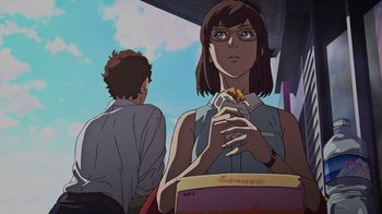 Movie still from “Mobile Suit Gundam: Hathaway” (2021), directed by Shûkô Murase – A woman holding a bag of fries while sitting next to a man; Medium shot, Low angle