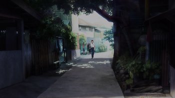 Movie still from “Mobile Suit Gundam: Hathaway” (2021), directed by Shûkô Murase – Two people walking down a sidewalk near a tree; Extreme Wide shot, High angle