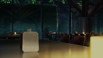Movie still from “Mobile Suit Gundam: Hathaway” (2021), directed by Shûkô Murase – A person sitting at a table in front of a large window; Extreme Wide shot, Over the shoulder angle