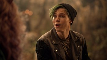 Movie still from “Monster High 2” (2023), directed by Todd Holland – A young man with green hair looking to his left; Close Up shot, Over the shoulder angle