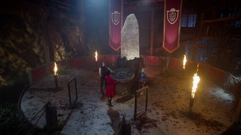 Movie still from “Monster High 2” (2023), directed by Todd Holland – A group of people standing around a large rock; Extreme Wide shot, High angle