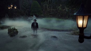 Movie still from “Monster High 2” (2023), directed by Todd Holland – A man standing in the middle of a foggy field at night; Wide shot, High angle