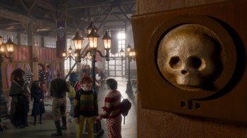 Movie still from “Monster High 2” (2023), directed by Todd Holland – A group of people standing in a room with lights; Close Up shot, High angle
