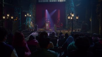 Movie still from “Monster High 2” (2023), directed by Todd Holland – A crowd of people sitting in front of a stage; Extreme Wide shot, High angle