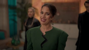 Movie still from “Monster High 2” (2023), directed by Todd Holland – A woman in a green dress smiling for the camera; Close Up shot, Over the shoulder angle