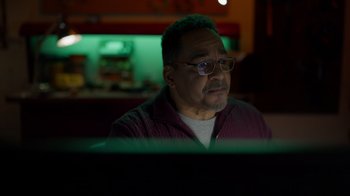 Movie still from “Monster High 2” (2023), directed by Todd Holland – A man sitting in front of a computer monitor; Close Up shot, Low angle